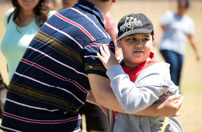 Care worker hugging boy